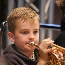 Young boy playing trumpet