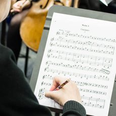 Image of student marking a musical score