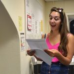 Girl receiving exam results and beaming