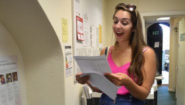 Girl receiving exam results and beaming