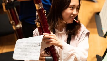 Woodwind student at Chetham's on The Stoller Hall stage
