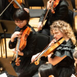 A group of chethams students with violins