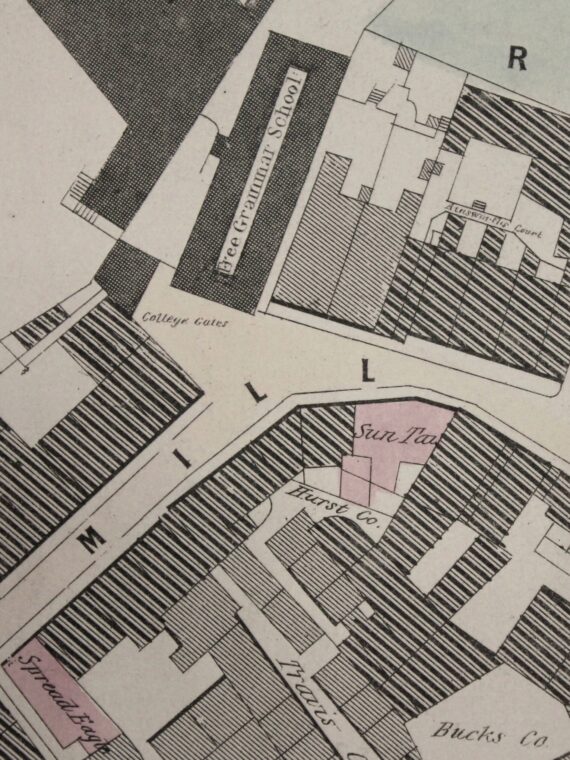 Alt text: An old map of Manchester that has been coloured in pale pink and blue. It shows the Sun Inn opposite the entrance to Chetham's Library on Long Millgate.