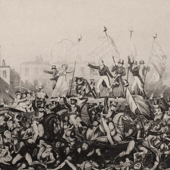 A print depicting the Peterloo Massacre. Several figures in early nineteenth-century dress stand on a raised platform carrying flags bearing political slogans, while mounted soldiers with swords ride through a crowd of panicked figures, trampling some underfoot.