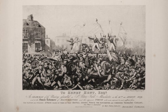 A print depicting the Peterloo Massacre. Several figures in early nineteenth-century dress stand on a raised platform carrying flags bearing political slogans, while mounted soldiers with swords ride through a crowd of panicked figures, trampling some underfoot