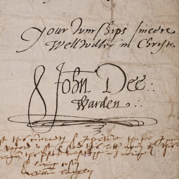 The corner of a sheet of sheet of paper containing a letter. A cursive hand has written ‘Your wurships sincere wellwisher in Christe’, and beneath it written ‘John Dee: Warden’.