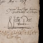 The corner of a sheet of sheet of paper containing a letter. A cursive hand has written ‘Your wurships sincere wellwisher in Christe’, and beneath it written ‘John Dee: Warden’.
