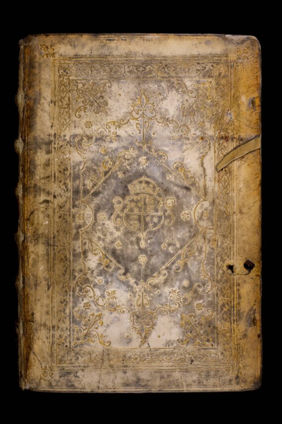 The cover of a book bound in white deerskin, with an elaborate gild-stamped floral design. At the centre of the design is a shield containing the English royal coat of arms. On either side of the shield, the letters ‘H’ and ‘R’ have been stamped.