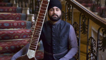 Jasdeep Singh Degun sits holding a sitar