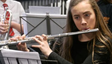Tameside Music Service, featuring a young musician playing the flute