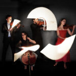 Ligeti Quartet performing with their bows tracing light waves
