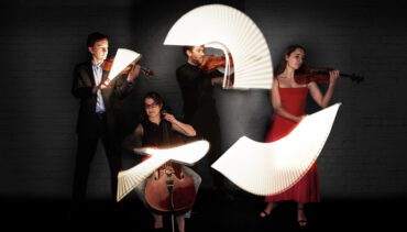 Ligeti Quartet performing with their bows tracing light waves