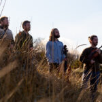 Maxwell Quartet standing in a field