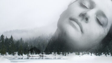 Black and white photo of a woman's face superimposed on a forest landscape