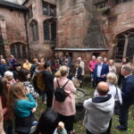 A tour group outside Chetham's medieval buildings