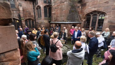 A tour group outside Chetham's medieval buildings