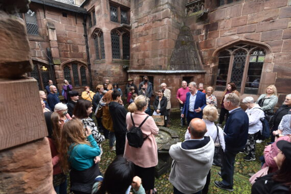 A tour group outside Chetham's medieval buildings