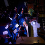 An overhead shot of manchester Baroque performing, lit by blue lights