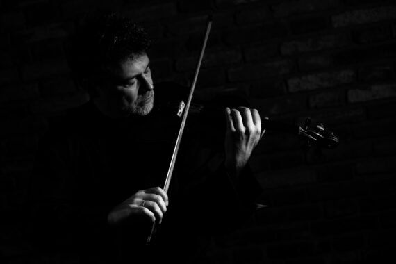Black and white image of musican Pavel Fischer playing the violin