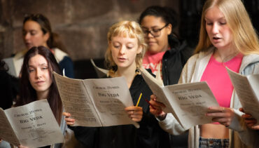 A group of singers holding music scores