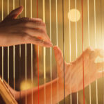 hands on harp strings