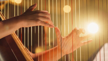 hands on harp strings