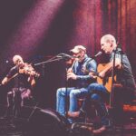 Musicians Mike McGoldrick, John Doyle and John McCusker performing