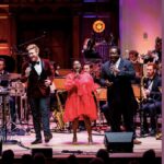 Singers and musicians of Down for the Count Orchestra on stage
