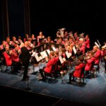 burbage brass band performing on stage in red uniforms