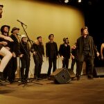 Members of the Spooky Men's chorale singing on stage