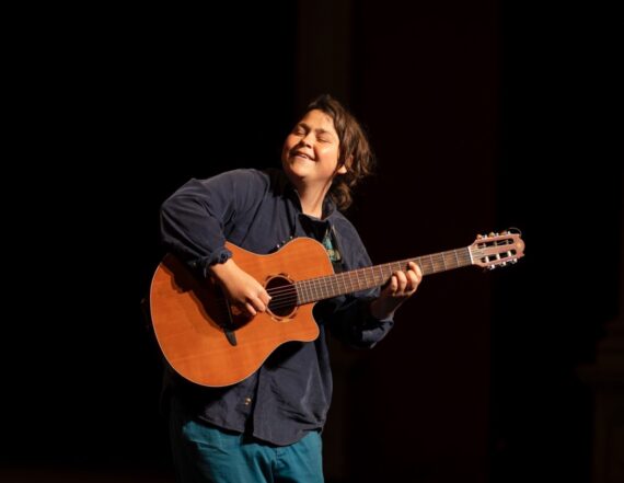 musician Mica Sinclair with guitar