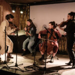 A string quartet performing on stage