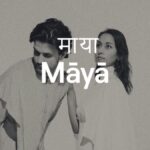 Text reads: माया Māyā over a black and white picture of two of the musicians performing