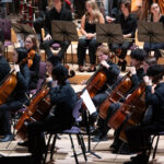 Members of Chethams Symphony Orchestra performing on stage