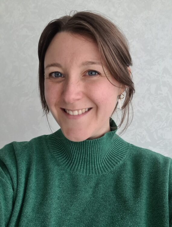 headshot of women in green top 