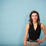 Comedian Melanie Bracewell on blue background