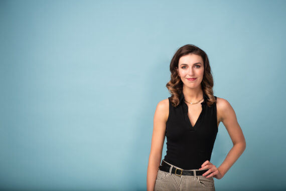 Comedian Melanie Bracewell on blue background