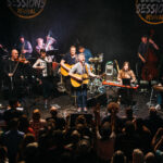 Musicians of the Seeger Sessions Revival performing on stage