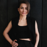 Pianist Anna Tsybuleva in black clothes on a black background