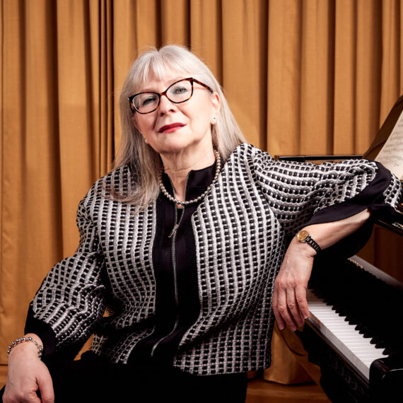 Photo of pianist Dina Parakhina seated at the piano