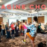 Text reads Imagine Choir, with a group of a group of people with raised arms