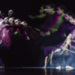 two dancers against a black backdrop