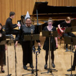 A group of Chetham's students singing with microphones