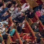 A family audience seated in the stoller hall