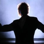 Silhouetted man with microphone