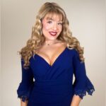 Singer Grace O'Malley, a women with long blonde hair wearing a blue dress, on a beige background