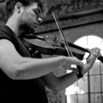 Black and white photo of musician Timothy Ridout with instrument