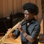 A student playing the soprano saxophone